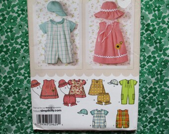2000s sewing pattern Simplicity 4243 baby and toddlers romper in two lengths dress top panties and hats sizes XXS-XS-S-M-L UNCUT