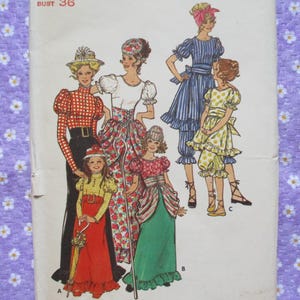 May include: Vintage sewing pattern featuring illustrations of women and children in various outfits. The designs include dresses, blouses, and pants with ruffles, bows, and patterned fabrics. The bust size is 36 inches.