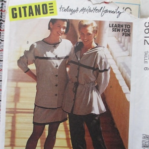 May include: Vintage Gitano sewing pattern featuring two women modeling outfits. One woman wears a striped button-down dress, the other a hooded jacket and pants. The pattern includes the text "Learn to Sew for Fun."