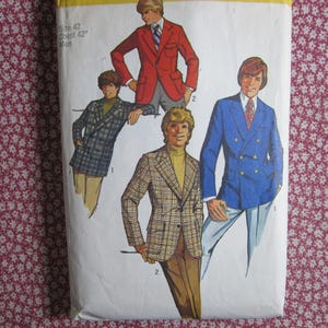 May include: A sewing pattern envelope featuring illustrations of three blazers: a red single-breasted blazer, a blue double-breasted blazer, and a plaid blazer with a turtleneck. Text on the envelope reads Size 42 Chest 42 Men.