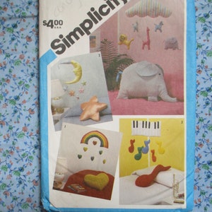 vintage 1980s sewing pattern Simplicity 6480 set of mobiles and pillows rainbows hearts moon stars circus animals musical UNCUT
