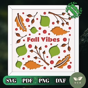 May include: A square white frame containing a layered paper-cut design with the text Fall Vibes in red. The design features orange and green leaves, brown branches with berries, and small red circles scattered across a white background.