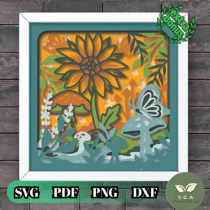 Puede incluir: Una obra de arte de papel multicapa en un marco blanco que presenta un gran girasol naranja, varios hongos y una mariposa. El diseño incluye follaje verde y elementos de fondo naranja. El texto "extra bonus" aparece en la esquina superior derecha.