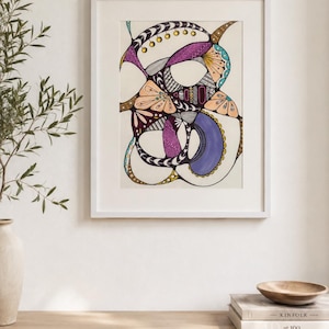 May include: A framed abstract drawing featuring intricate black ink lines, swirling organic shapes, and filled-in sections of purple, peach, and teal. The artwork is displayed in a white frame, showcasing a complex composition of patterns and colours.