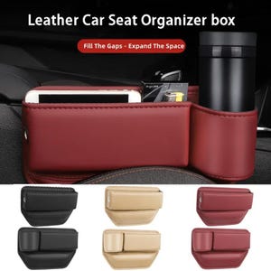 Pode incluir: Um organizador de assento de carro em couro vermelho com porta-copos e compartimento para smartphone. O texto "Leather Car Seat Organizer box" e "Fill The Gaps - Expand The Space" é visível. Versões adicionais em preto, bege e vermelho são exibidas.