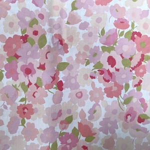 Puede incluir: Tela floral con un patrón repetitivo de flores rosas y rojas con hojas verdes sobre un fondo blanco. Las flores varían en tamaño y forma, creando un diseño suave y femenino.
