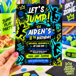 May include: A rectangular birthday party invitation with a black background featuring neon green and blue paint splatter effects. The text reads Let's Jump! Aiden's 11th Birthday, Saturday, November 14 at 2:00 PM, Sky Zone Adventure Park, 300 West Harbor Drive, Tucson, AZ 85711, Pizza, Cake, Jumping, RSVP Jessica 555-841-7306.