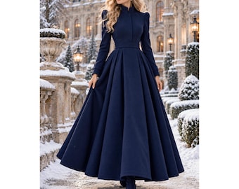 May include: A floor-length navy blue coat featuring a high collar, long sleeves with structured shoulders, and a fitted waist that transitions into a full, pleated skirt. The garment is constructed with a solid, smooth fabric texture.