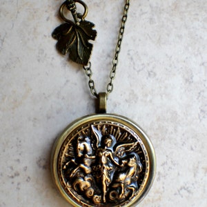 Music box locket, round locket with music box inside, in bronze with angel and horses medallion. image 4