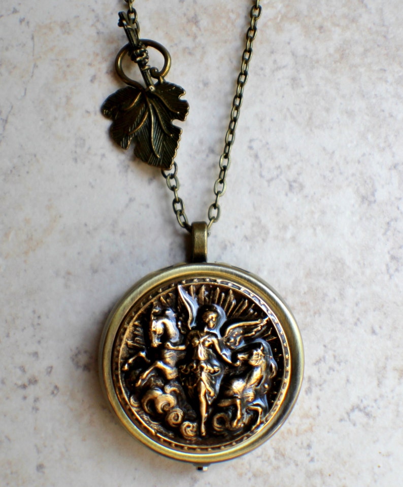 Music box locket, round locket with music box inside, in bronze with angel and horses medallion. image 4