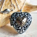 Music box locket,  heart shaped locket with music box inside, in silver tone with heart on front cover. 