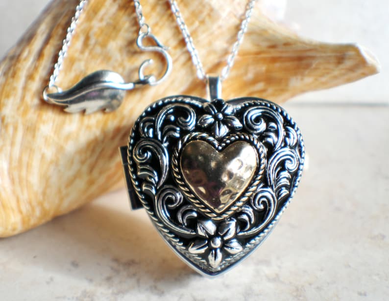 Music box locket,  heart shaped locket with music box inside, in silver tone with heart on front cover. 