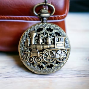 Train pocket watch, men&#39;s mechanical pocket watch with train mounted on front case in bronze.