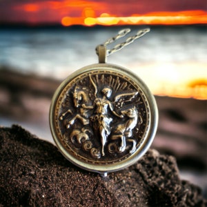 Music box locket, round locket with music box inside, in bronze with angel and horses medallion. image 1