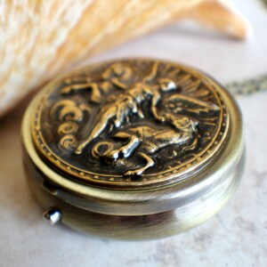 Music box locket, round locket with music box inside, in bronze with angel and horses medallion. image 2