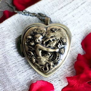 Music box locket,  heart shaped locket with music box inside, in bronze with a mermaid and seahorse.