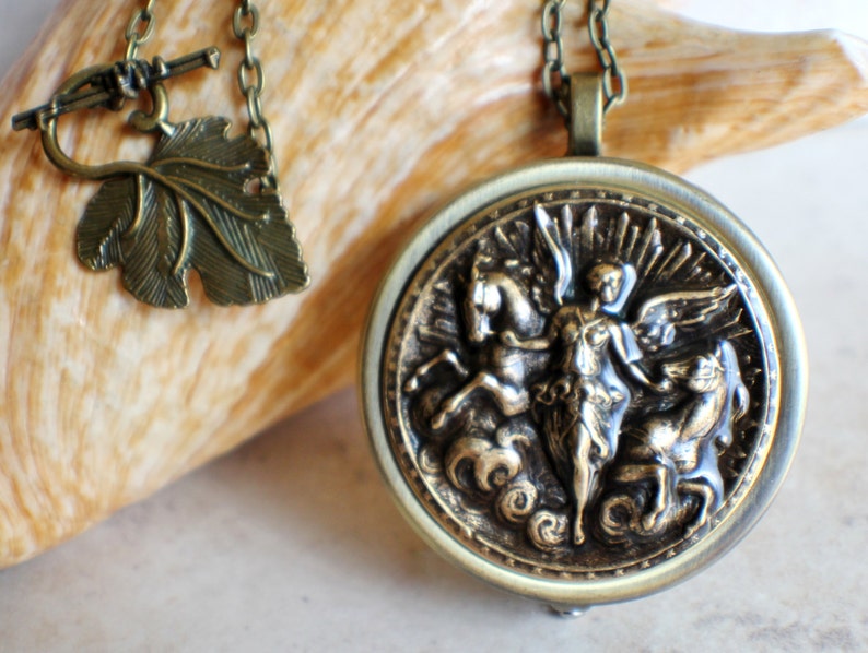 Music box locket, round locket with music box inside, in bronze with angel and horses medallion. image 6