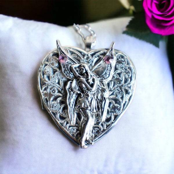 Music box locket,  heart shaped locket with music box inside, in  silvertone with fairy.