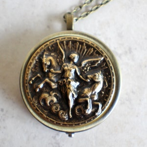 Music box locket, round locket with music box inside, in bronze with angel and horses medallion. image 3