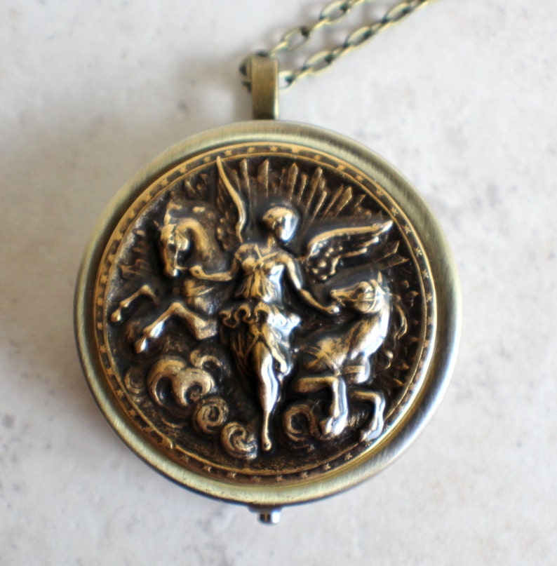 Music box locket, round locket with music box inside, in bronze with angel and horses medallion. image 3