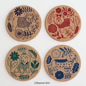 May include: Four cork coasters with different dog breeds wearing clothes and surrounded by flowers and leaves. The dogs are a French Bulldog, a Shih Tzu, a Poodle, and a Dachshund. The coasters are in blue, green, red, and black.