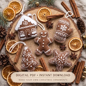 May include: A set of five felt Christmas ornaments including a gingerbread house, a gingerbread person, a mitten, a Christmas tree, and a star, all featuring white embroidered details and white hanging loops, arranged on a wooden slice.
