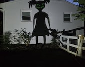 Zombie Girl with pigtails and green eyes Halloween Shadow Caster, Chainsaw Decor, Scary Outdoor Halloween with a killer shadow