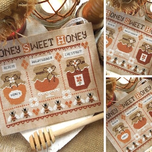 May include: Cross stitch pattern featuring four jars of honey labeled "Realm", "Wildflower", "Chestnut", and "Honey". The jars are surrounded by bees and hearts. The text "Honey Sweet Honey" is at the top of the pattern.