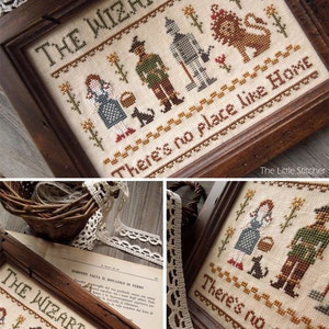 Peut inclure: Une broderie au point de croix encadr&eacute;e repr&eacute;sentant les personnages du Magicien d'Oz, dont Dorothy, l'&Eacute;pouvantail, l'Homme de Fer-Blanc et le Lion peureux. La broderie est r&eacute;alis&eacute;e sur un tissu beige avec des points de couture marrons. Le cadre est en bois fonc&eacute;. Le texte "THE WIZARD OF OZ" et "There's no place like Home" est brod&eacute; en fil marron.
