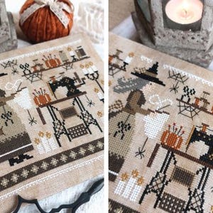 May include: Cross-stitch sampler depicting a witch at her sewing table, with Halloween motifs. The design includes a witch in a hat, a sewing machine, pumpkins, spiders, and candles. The colour palette is mainly beige, brown, and orange.