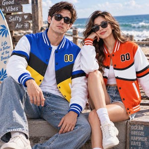 May include: A blue, black, and yellow color-blocked varsity jacket with white sleeves and the number 00 on the chest, paired with an orange, white, and black color-blocked varsity jacket with white sleeves and the number 00 on the chest.