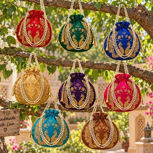 May include: Eight round drawstring pouches in red, green, blue, gold, purple, magenta, teal, and brown. Each pouch features gold peacock embroidery, a pearl bead handle, and a wooden sign reading Handmade With Love with a heart symbol.