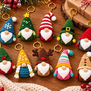 May include: A collection of ten crocheted gnome keychains featuring various designs, including hats with snowflakes, stripes, reindeer antlers, and festive colors like red, green, blue, yellow, and brown, each with a white beard and gold keyring.