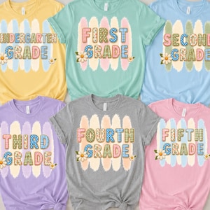 May include: Six short-sleeve t-shirts in yellow, mint green, light blue, lavender, gray, and pink. Each shirt features a central graphic with brushstroke backgrounds, daisy accents, and text reading Kindergarten, First, Second, Third, Fourth, and Fifth Grade.