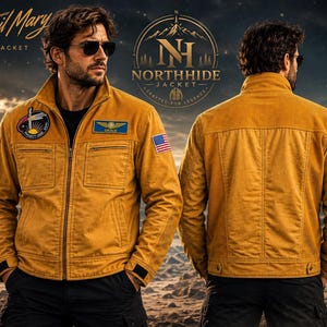 May include: A mustard yellow jacket featuring a front zipper, two chest pockets, and long sleeves with adjustable cuffs. The garment displays a Project Hail Mary patch, a NASA logo, a Grace name tag, and a United States flag patch on the sleeve.