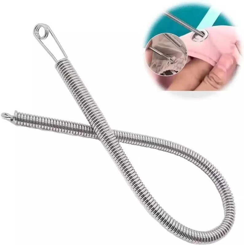 May include: A silver-colored metal flexible threading tool featuring a coiled spring body and a safety pin-style closure at one end. The tool is designed for pulling elastic or drawstrings through fabric casings, as shown in the circular inset.