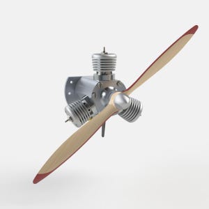 May include: A three-cylinder radial engine featuring silver metallic cooling fins and a central hub. Attached to the front is a two-blade wooden propeller with distinct red-painted tips, showcasing a polished metallic spinner at the center point.