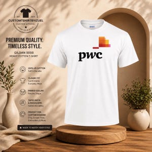 May include: A white short-sleeved Gildan 5000 heavy cotton t-shirt featuring the black text 'pwc' and a multi-colored pixelated square graphic above the letters. The shirt has a classic fit, a ribbed collar, and taped neck and shoulders.