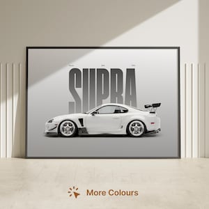 May include: A framed horizontal wall art print featuring a side profile of a white sports car with a rear spoiler. The word SUPRA is printed in large, bold, dark gray vertical lettering behind the car, with smaller text above the car.