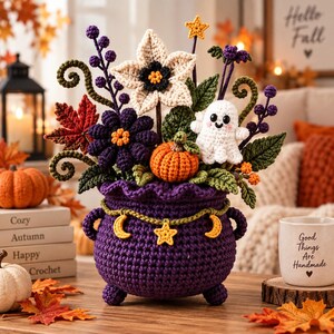 May include: A purple crocheted cauldron filled with a bouquet of crocheted autumn elements including a white flower, a small white ghost, an orange pumpkin, dark purple flowers, green leaves, and a garland featuring yellow stars and crescent moons.