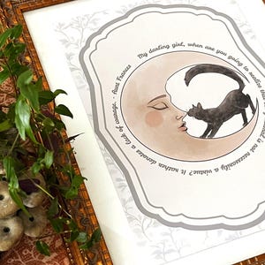 May include: A framed print featuring a crescent moon with a human face and a black cat. The text reads: My darling girl, when are you going to realise that being normal is not necessarily a virtue? It rather denotes a lack of courage. - Aunt Frances.