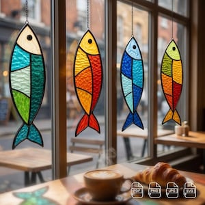 May include: Four hanging stained glass fish ornaments with black metal frames. Each fish features a unique color palette including teal, green, yellow, orange, red, and blue textured glass segments. Each piece hangs from a thin metal chain.