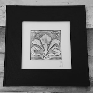 May include: Black and white framed print of a stylised floral design. The design features a central flower with two curved stems on either side. The print is in a black frame with a white mount.