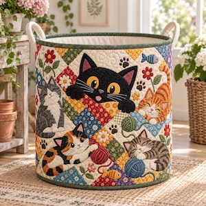 May include: A cylindrical fabric storage basket featuring a quilted patchwork design with various cat illustrations, including a large black cat, a calico cat, a tabby cat, and a grey cat, accented with yarn balls, flowers, and fish motifs.