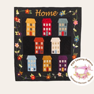 May include: A PDF sewing pattern for a quilt featuring a black background with a floral vine border and a grid of colourful houses. The title of the pattern is "Home" and the designer is "Sallieann Harrison - Quilter".