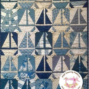 May include: A quilt pattern featuring a blue and white sailboat design. The pattern is surrounded by a white border with a scalloped edge. The pattern is titled "PDF Sewing Pattern" and includes the name "Sallieann Harrison, Quilter".