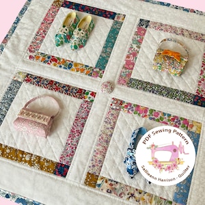 May include: A white quilted fabric square with a floral pattern. The fabric is cut into squares and rectangles and sewn together to create a patchwork design. There are three miniature fabric accessories on the quilt: a pair of shoes, a small purse, and a larger purse. A circular label with the text "PDF Sewing Pattern Sallieann Harrison - Quilter" is in the lower right corner of the image.