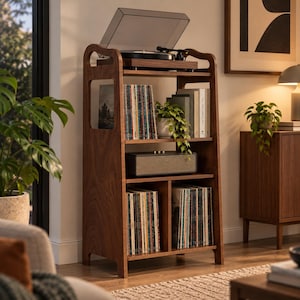May include: A tall, dark wood record player stand featuring an open-frame design with four shelves. The top shelf holds a turntable, while the lower shelves store vinyl records, a rectangular speaker, and a small potted plant.