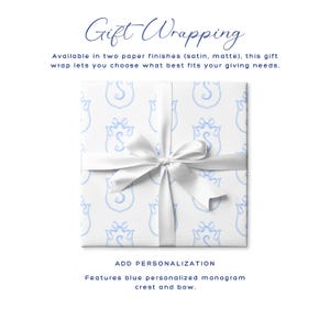 May include: White gift wrap with a blue monogram crest pattern, tied with a white satin bow. The text "Gift Wrapping" is at the top, with additional text below describing the paper finishes and personalization options.