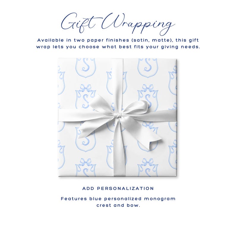 May include: White gift wrap with a blue monogram crest pattern, tied with a white satin bow. The text "Gift Wrapping" is at the top, with additional text below describing the paper finishes and personalization options.